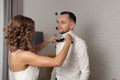 Bride fixes bow tie on groom s neck