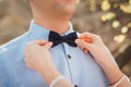 The Bride Fixing Groom`s Bow Tie Royalty Free Stock Photo