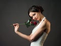 Bride with a flower. Beautiful woman with red roses Royalty Free Stock Photo