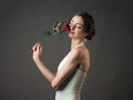 Bride with a flower. Beautiful woman with red roses Royalty Free Stock Photo
