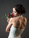 Bride with a flower. Beautiful woman with red roses Royalty Free Stock Photo