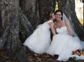 Bride and flower girl under tree