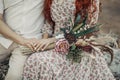 The bride and the boho flowers in her hand