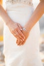 The bride folded her hands with a wedding ring on her finger and a bracelet, close-up Royalty Free Stock Photo