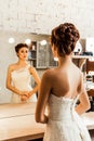 Bride gazing into the mirror