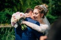 The bride gently kisses the bride and presses against her. The wife warmly embraces her husband on the day of their Royalty Free Stock Photo