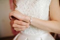 Bride getting bracelet dressed on her wedding day Royalty Free Stock Photo