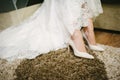 Bride getting dressed shoes on her wedding day Royalty Free Stock Photo