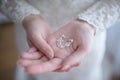 Bride getting ready for the wedding ceremony with focus on her hands holding delicately a pair of silver crystal drop earrings Royalty Free Stock Photo