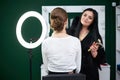 Bride getting ready for wedding. Professional make-up artist applying blush on female clients` face with big makeup brush. Work Royalty Free Stock Photo