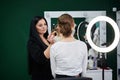 Bride getting ready for wedding. Professional make-up artist applying blush on female clients` face with big makeup brush. Work Royalty Free Stock Photo