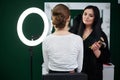 Bride getting ready for wedding. Professional make-up artist applying blush on female clients` face with big makeup brush. Work Royalty Free Stock Photo