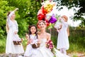 Bride with girls as bridesmaids, flowers and balloons