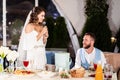 The bride gives a speech into the microphone and congratulates the groom.