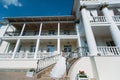 The bride goes up the stairs to the building with the columns. She holds a skirt of her white wedding dress, a bouquet Royalty Free Stock Photo