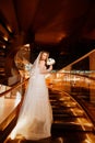 Bride on a golden spiral staircase.