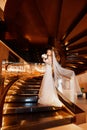 Bride on a golden spiral staircase.