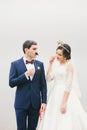 Bride and groom attached to face paper mustache , crown Royalty Free Stock Photo