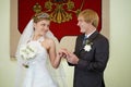 Bride and groom on background of coat of arms