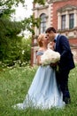 Bride and groom on the background of an old estate. Classical wedding.Wedding walk and photo shoot. Embraces and kiss Royalty Free Stock Photo