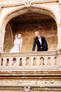 Bride and groom on the balcony in the old castle. Royalty Free Stock Photo