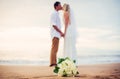 Bride and groom on beach at sunset Royalty Free Stock Photo
