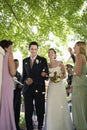 Bride And Groom Being Showered With Flower Petals