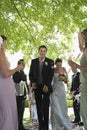 Bride And Groom Being Showered With Flower Petals