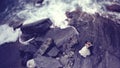 Bride and groom on a big rock near the sea