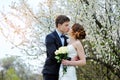 Bride and groom with a bouquet of walking in the summer park Royalty Free Stock Photo