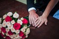 Bride and groom hands with flower bouquet on the table Royalty Free Stock Photo