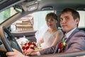 Bride and groom in a car in a wedding Royalty Free Stock Photo