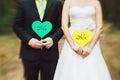 Bride and groom with cards in shape of heart Royalty Free Stock Photo