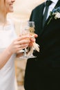 Bride and groom clink glasses of champagne. Close up Royalty Free Stock Photo