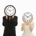 Bride and groom with clocks.