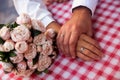 Bride and groom close up of hands with rings and wedding bunch of flowers