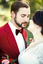The bride and groom closeup, before kiss, outdoor, tenderness, passion. Wedding style Marsala, vertical portrait.