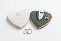 Bride and groom cookies and wedding bands Royalty Free Stock Photo