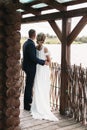 Bride and groom in a country house looking into distance on the lake Royalty Free Stock Photo