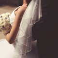 Bride and groom couple closeup, veil wedding dress with bouquet flowers Royalty Free Stock Photo