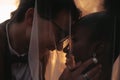 Bride and groom covered with veil close-up. Interracial marriage. Asian bride and groom