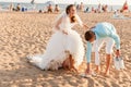 Bride and groom at the crowded beach