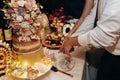 Bride and groom cut beautiful rustic wedding cake Royalty Free Stock Photo