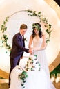 Bride and groom cutting their rustic wedding cake. beautiful wedding cake. wedding reception outdoors. Royalty Free Stock Photo