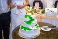 A bride and a groom is cutting their wedding cake. beautiful cake. nicel light. wedding concept Royalty Free Stock Photo