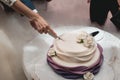 A bride and a groom is cutting their wedding cake. beautiful cake. nicel light. wedding concept Royalty Free Stock Photo