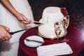 bride and groom cutting wedding cake and tasting at wedding ceremony reception, catering in restaurant Royalty Free Stock Photo