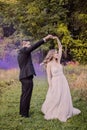 Bride and Groom dancing in forest with purple smoke Royalty Free Stock Photo