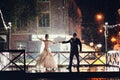 Bride and groom dancing in the night