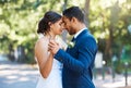 Bride and groom dancing outside. Mixed race newlyweds enjoying romantic moments on their wedding day. Happy young Royalty Free Stock Photo